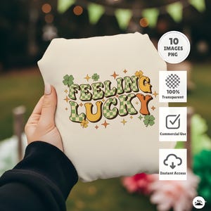 May include: A cream-colored tote bag with the words "Feeling Lucky" in a retro font. The text features green checkered and orange lettering, with shamrock and star accents. The bag is a PNG image.