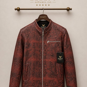 May include: A red and black snakeskin-patterned leather jacket with a zipper closure and a small chest pocket. The jacket is hanging on a wooden hanger with the brand name "ZEZEFY" visible.
