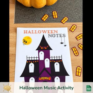 May include: A white paper sheet titled Halloween Notes featuring a purple and black haunted house illustration with labeled windows A through G, a yellow moon with black bats, two hanging spiders, and several small yellow window cutouts nearby.