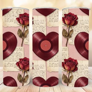May include: A tumbler with a romantic design featuring red roses, vintage vinyl records, and handwritten script on a pink background. The design includes a heart-shaped vinyl record. The tumbler is cylindrical.