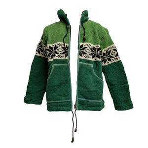 May include: A green and white zip-up jacket with a hood and two front pockets. The jacket features a snowflake pattern on the upper chest and sleeves. The jacket is made of a thick, textured material.