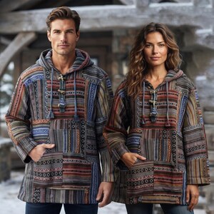 May include: Two hooded pullovers featuring a patchwork design with various woven patterns in shades of brown, blue, grey, and rust. Each garment includes a front kangaroo pocket, long sleeves, and a central placket with toggle closures and drawstrings.