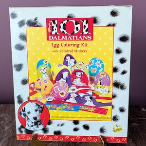 May include: A 101 Dalmatians Egg Coloring Kit with colorful stickers. The box features images of decorated eggs and a Dalmatian puppy. The packaging is white with black spots and a yellow background.