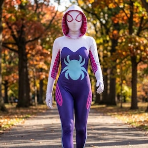 May include: A full-body hooded jumpsuit featuring a purple torso with a light blue spider emblem, white sleeves, and pink web patterns on the hood and sides. The garment includes a matching white mask with large white eye lenses and purple trim.