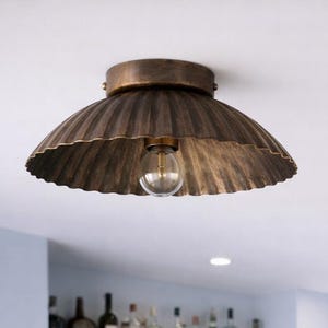 May include: A set of three ceramic mugs with a speckled, cream-colored glaze. Each mug features a different hand-painted floral design in shades of blue, green, and yellow. The mugs have a simple, rounded shape and a comfortable handle.