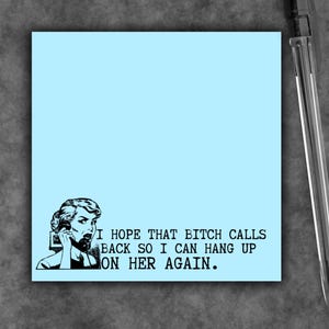 May include: A square light blue sticky note featuring a black and white vintage-style illustration of a person holding a telephone receiver to their ear, accompanied by the text: I HOPE THAT BITCH CALLS BACK SO I CAN HANG UP ON HER AGAIN.