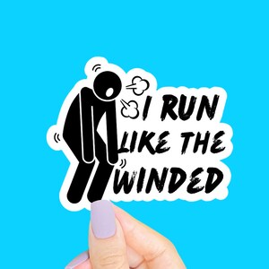 May include: A die-cut sticker featuring a black stick figure bent over in exhaustion with visible motion lines and a puff of air. The text reads I RUN LIKE THE WINDED in a bold, black, distressed font. The design has a white border.