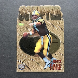 May include: A gold and brown football card featuring Brett Favre, a Green Bay Packers quarterback, throwing a football. The card has the text "SCOOTED" at the top and "NFL EXPERIENCE" at the bottom.