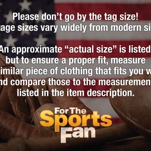 May include: Vintage sports equipment, including a basketball, baseball glove, baseball bat, and football, are arranged on a wooden surface in front of an American flag. The text "Please don't go by the tag size! Vintage sizes vary widely from modern sizes. An approximate "actual size" is listed, but to ensure a proper fit, measure a similar piece of clothing that fits you well and compare those to the measurements listed in the item description. For The Sports Fan" is displayed on the image.