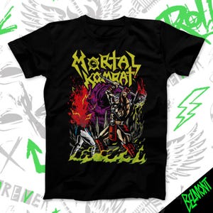May include: Black t-shirt featuring a graphic from the video game Mortal Kombat. The design includes the game's logo in yellow, and a fighting scene with characters in red, purple, and green.