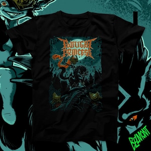 May include: Black t-shirt featuring a graphic design with the text "Twilight Princess" in orange, above a dark illustration of a creature. The artwork includes teal and orange accents, with a full moon in the background. The shirt is a crew neck.