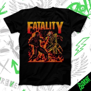 May include: Black t-shirt featuring a fiery graphic with the word "FATALITY" in orange and red. The design depicts two skeletal figures in combat, surrounded by flames. The shirt has a classic crew neck.