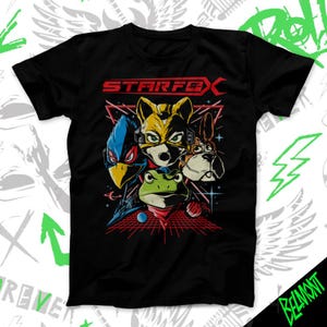 May include: Black t-shirt featuring a graphic of characters from Star Fox, including a fox, bird, frog, and dog. The word "STARFOX" is printed in red and yellow. The design is set against a red grid and star background.