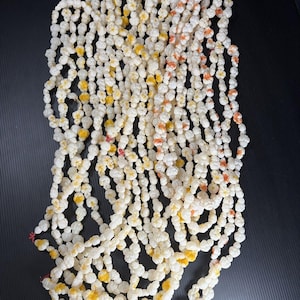 May include: A set of three ceramic mugs with a speckled, matte finish. The mugs are in shades of cream, light gray, and dark gray. Each mug has a simple, minimalist design, perfect for coffee or tea.