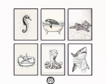 May include: Six framed black and white art prints featuring aquatic animals. The prints include a seahorse, a whale in a bathtub, a turtle with a towel, a starfish on soap, an octopus with a towel, and a shark with a towel.