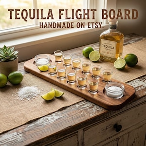 May include: A wooden tequila flight board with shot glasses, salt, and lime wedges. A bottle of tequila is in the background. The text "TEQUILA FLIGHT BOARD HANDMADE ON ETSY" is at the top of the image.