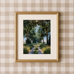 May include: A framed wall art print featuring a dirt path lined with tall green trees, creating a natural canopy over the road. The scene includes grassy fields on both sides under a bright sky. The print is encased in a metallic gold frame.