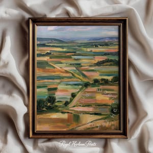 May include: A framed landscape painting featuring a patchwork of fields in shades of green, yellow, and pink under a soft sky. The artwork is enclosed in a dark brown wooden frame with a textured finish. The text Royal Heirloom Prints is visible.