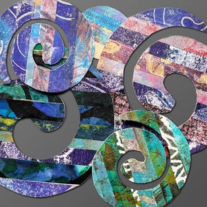 May include: A collage art piece composed of three overlapping spiral shapes. The surfaces feature a textured mix of blue, purple, green, and pink paper strips with visible printed text fragments, creating a layered, multi-colored abstract design.