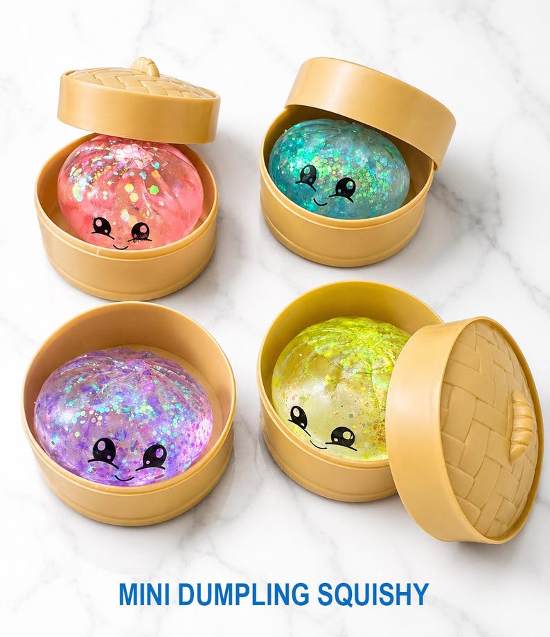 May include: Four round, tan plastic containers resembling bamboo steamers, each holding a translucent, glitter-filled squishy toy shaped like a dumpling. Each toy features a printed smiling face with black eyes and a mouth. Text reads: MINI DUMPLING SQUISHY.
