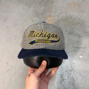 Gorra snapback vintage de lana Melton de los Michigan Wolverines de los años 90, con diseño de cola de caballo, color azul marino y gris