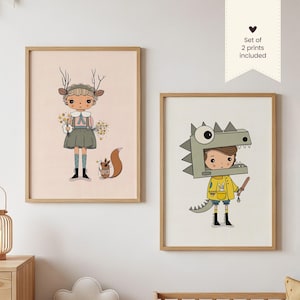 May include: Two framed art prints. One depicts a girl with antlers and a squirrel, holding flowers. The other shows a child in a dinosaur costume. Both prints are in light wood frames, with the text "Set of 2 prints included".