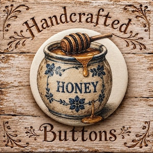 May include: A circular button featuring a tan ceramic honey pot with blue floral accents and the word HONEY printed in blue. A wooden honey dipper rests on top with golden honey dripping down the side. The background is a light wood texture.