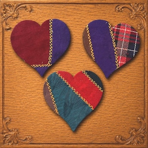 May include: Three heart-shaped fabric patches featuring patchwork designs joined by yellow cross-stitching. The hearts display various colors and patterns, including solid maroon, purple, red, dark teal, and a red, black, and white plaid fabric.