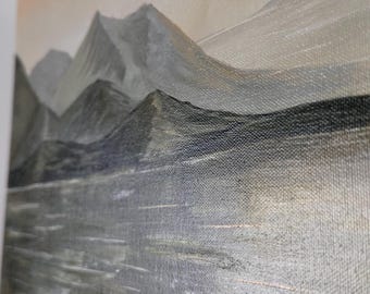 May include: An original landscape painting on canvas. The artwork depicts a mountain range in shades of gray and black, with a reflective body of water in the foreground. The sky is a soft, muted peach color, creating a serene and natural scene.