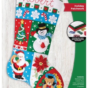 May include: A Bucilla Holiday Patchwork felt stocking kit measuring 18 inches. The white felt stocking features the name Robert embroidered in red, with colorful appliqués of a snowman, Santa Claus, a Christmas tree, a poinsettia, and a teddy bear.
