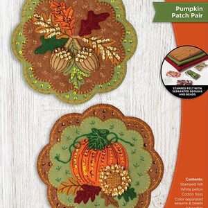 May include: Felt wall hanging kit featuring two decorative pieces. One design showcases acorns and leaves, the other a pumpkin and sunflower. Each piece measures 8 in x 8 in (20.3 cm x 20.3 cm). Includes stamped felt, sequins, beads, and instructions.