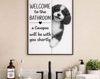 May include: Black framed bathroom wall art with a black and white Cavapoo dog illustration. The text reads "WELCOME to the BATHROOM" above a heart and "a Cavapoo will be with you shortly."