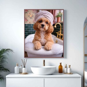 May include: A framed print of a dog in a bathtub, wearing a towel on its head and a monocle. The dog is a light brown color and is surrounded by bubbles. The background includes a vintage-style bathroom with a floral wallpaper and gold fixtures.