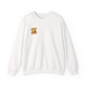 May include: White crew neck sweatshirt with long sleeves. A small graphic on the upper left chest features text and an illustration of a bowl of soup. The text reads "Hot Soup, Everything".
