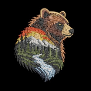 May include: Embroidered design of a bear's head with a landscape scene inside. The landscape features a river, trees, mountains, and a sunset. The bear is brown with a black background.