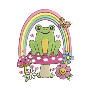 May include: An embroidered design featuring a smiling green frog sitting on a pink mushroom with white polka dots. A rainbow arches over the frog, and a butterfly and flowers surround the mushroom. Pink hearts are scattered throughout the design.