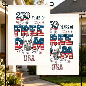 May include: A white garden flag featuring the text 250 YEARS OF FREEDOM USA EST. 1776. The design includes a bald eagle head, a skeleton hand making a rock-and-roll gesture, and red, white, and blue star and stripe patterns with fireworks.