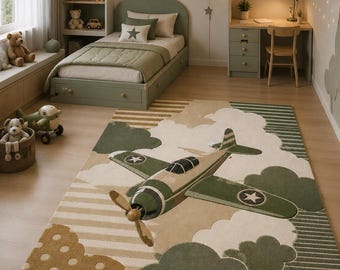 May include: A rectangular area rug featuring a large vintage-style propeller aeroplane flying through white clouds. The design incorporates olive green, tan, and cream tones with patterns including polka dots, horizontal stripes, and solid blocks.