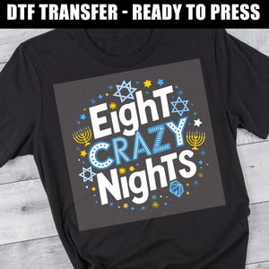 May include: Black t-shirt with a white graphic design that says "Eight Crazy Nights" surrounded by blue and yellow stars and menorahs.