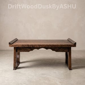 May include: A handcrafted, dark brown wooden bench with a rectangular top and decorative carved details. The bench has a low profile and sturdy legs, suitable for various interior settings. The text "DriftWoodDuskByASHU" is visible.