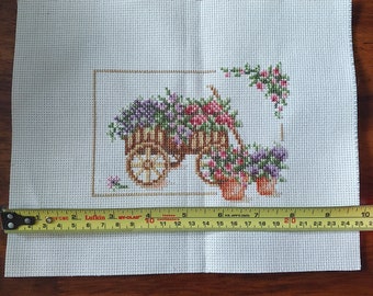 Finished flower cart cross stitch unframed.