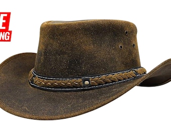 Puede incluir: Sombrero de vaquero marrón desgastado con una banda trenzada y ribete blanco cosido. El sombrero tiene un ala ancha y una corona ligeramente hundida. Estilo rústico, adecuado para actividades al aire libre.