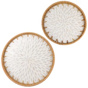 以下が含まれることがあります： 白い背景に白い花柄の2つの丸いコースター。コースターは、装飾的なステッチが施された、織り込まれた薄茶色の縁取りが施されています。コースターは、飲み物の輪から表面を保護するように設計されています。