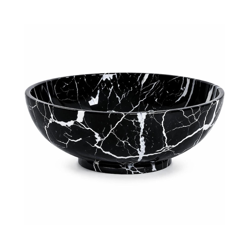 May include: A round bowl featuring a black base color with a prominent white veined pattern throughout the interior and exterior surfaces. The bowl has a smooth, polished finish and sits on a circular pedestal base, creating a deep basin shape.