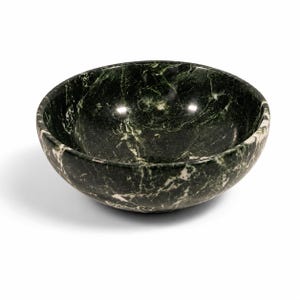 May include: A round bowl crafted from dark green marble featuring prominent white veining throughout the stone surface. The bowl has a smooth, polished finish with a deep interior basin and a curved exterior wall, showcasing the natural patterns.