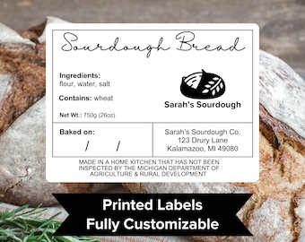 May include: Black and white printable label for sourdough bread. The label includes the name "Sourdough Bread", ingredients, net weight, and a space to write the date baked. It also includes the name "Sarah's Sourdough" and the company's contact information. The label states that the bread is made in a home kitchen and has not been inspected by the Michigan Department of Agriculture & Rural Development. The label also includes the text "Printed Labels" and "Fully Customizable".