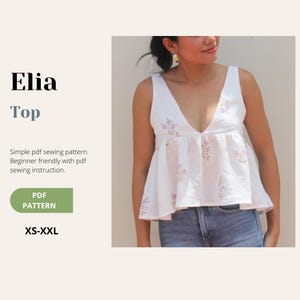 May include: A white sleeveless top with a deep V-neck and a floral design. The top features a gathered waist and is worn with denim shorts. The image includes text: "Elia Top", "PDF Pattern" and size range XS-XXL.