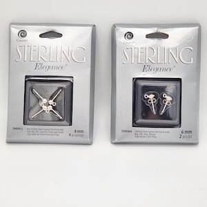 May include: Two packages of Cousin Sterling Elegance earrings. One package contains 4mm ball earrings, and the other contains 6mm saucer earrings. The packaging is silver with black text.