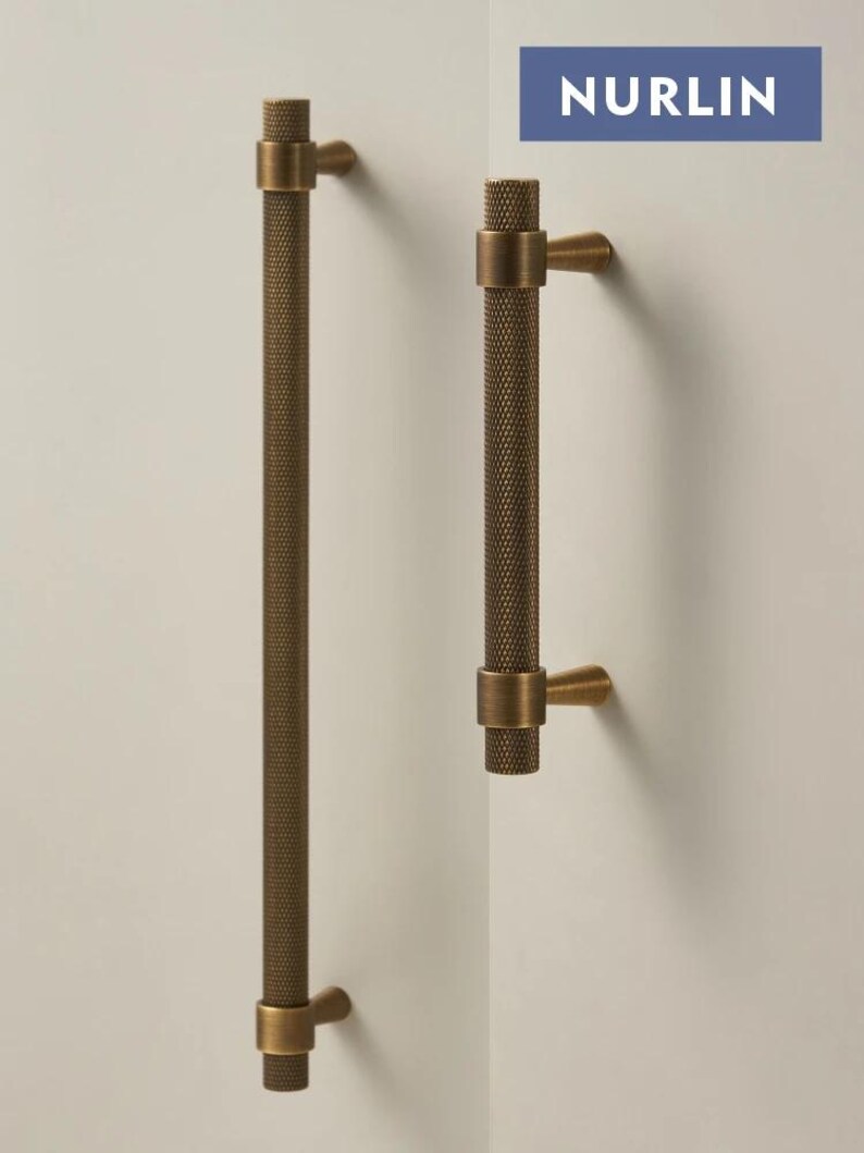 May include: A set of three ceramic mugs with a speckled, matte finish. The mugs are in shades of cream, light gray, and dark gray. Each mug has a simple, minimalist design and a rounded handle.