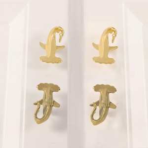 May include: A set of three ceramic mugs with a speckled, matte finish. The mugs are in shades of cream, light gray, and dark gray. Each mug has a simple, minimalist design and a rounded handle. The mugs are suitable for coffee, tea, or other beverages.